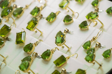 Sticker - Closeup shot of earrings with green precious stones