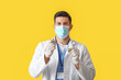 © Pixel-Shot - Male dentist in mask with plastic tooth on color background