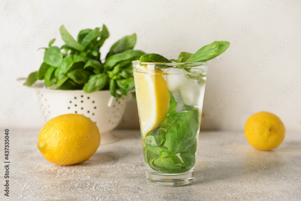 Glass of lemonade with basil on light background - obrazy, fototapety, plakaty 
