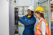 © nikomsolftwaer - Engineer Training Apprentices On CNC Machine. Factory worker is programming a CNC milling machine