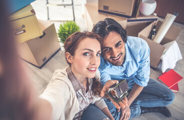 Wall Mural - Young couple moving in into new apartment