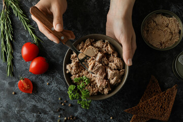 Concept of tasty eating with canned tuna on black smokey background