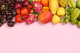 Fototapeta Tęcza - Assortment of fresh exotic fruits on pink background, flat lay. Space for text