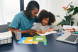 © Peakstock - Father helps his daughter doing school homework at home. Father's day, happy dad and schoolgirl, happy family