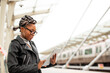 © JustLife - Happy young woman waiting for the train. African woman waiting for a subway train..
