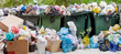Overloaded dumpster, full garbage container, household garbage bin, trash can, heap of unsorted rubbish: plastic bags, food, paper, glass bottles, metal scrap, pile of refuse, litter, waste management