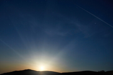 Canvas Print - Mountains with night sunset sky with many stars, full moon rising. Night sky background