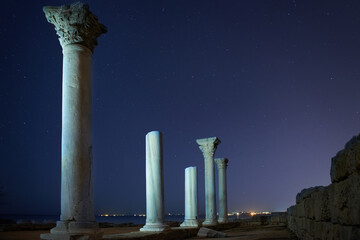 Wall Mural - ruins of ancient city columns under night sky