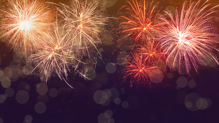 Beautiful bright fireworks lighting up night sky. Bokeh effect