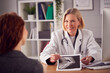 © Monkey Business - Mature Female Doctor Or Consultant Wearing White Coat Having Meeting With Woman Patient In Office