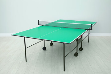 Sticker - One green ping pong table with net indoors