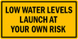Low water levels launch at your own risk Boat ramp sign. Safety signs and symbols.