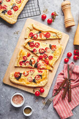 Wall Mural - Puff pastry tart with cherry tomatoes, mozzarella and purple basil