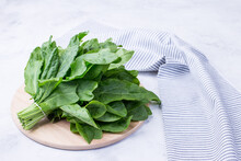 A Bunch Of Fresh Sorrel Leaves On A Light Background With A Napkin. Healthy Greens For A Healthy Diet. Vitamins In Natural Products.