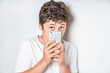 © Louis-Paul Photo - portrait of young and cute teenager isolated on white using cellphone sad and afraid