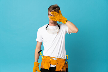 Young electrician man over isolated wall covering eyes by hands and smiling