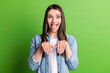 Portrait of attractive funky cheerful girl grimacing showing like dog paws isolated over bright green color background