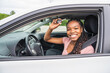 © Louis-Photo - Young black teenage driver seated in her new car