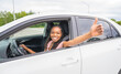 © Louis-Photo - Young black teenage driver seated in her new car