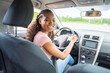 © Louis-Photo - Young black teenage driver seated in her new car