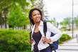 © Louis-Photo - A black adult woman university student on campus with backpack