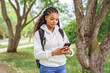 © Louis-Photo - cute black teenager university student on campus with backpack