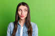© deagreez - Portrait of attractive curious girl thinking looking aside copy space pout lips isolated over bright green color background