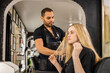 © SuperStock - Stylist consults with young woman before hair appointment at boutique salon