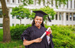 © Louis-Photo - happy afro american university graduates at graduation ceremony