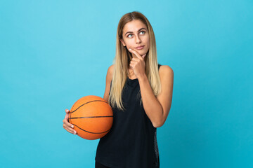 Young woman playing basketball  isolated on white background and looking up