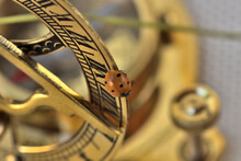 Detail Of A Ladybug Walking Past An Ancient Golden Navigation Instrument