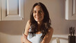 © LIGHTFIELD STUDIOS - happy woman smiling while looking at camera in kitchen