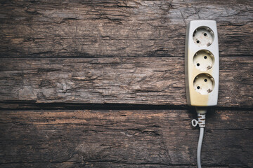 Canvas Print - Old white electric outlet on the old wooden floor flat lay background with copy space.