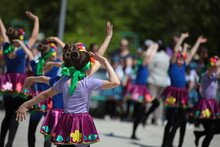 A Group Of Little Girls In Colorful Dresses With Beautiful Hairstyles Dance At An Outdoor Festival.Kids Party