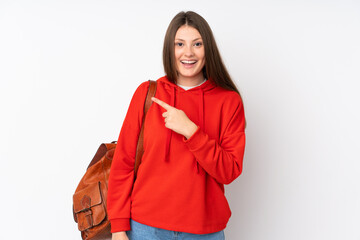 Teenager caucasian student girl isolated on white background pointing finger to the side