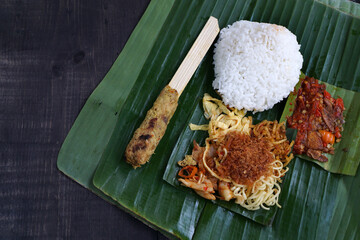 Balinese ready-to-eat street food, packaged in small portions of banana leaves called 