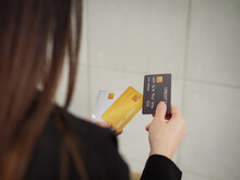 Close-up Of Three Mockup Credit Cards In A Businesswoman's Hands, A Rear View Of A Businesswoman In A Black Suit Is Holding Three Mockup Credit Cards In Her Hands.