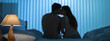 © realstock1 - The kissing couple sit on the bed. night time