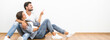© realstock1 - The smile couple sit and gesture on the background of the white wall