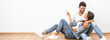 © realstock1 - The smile couple sit and gesture on the background of the white wall