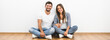 © realstock1 - The cheerful man and woman sit near the empty wall