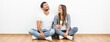 © realstock1 - The cheerful man and woman sit near the empty wall