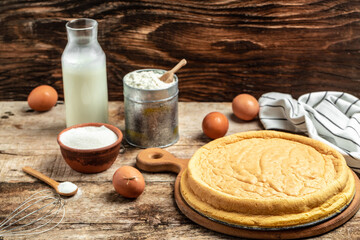 Homemade sponge cake with ingredients on a white wooden table. Bakery background concept. banner, menu recipe place for text