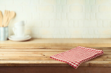 Wall Mural - Empty wooden table with tablecloth over kitchen shelf background.  Interior mock up for design and product display.