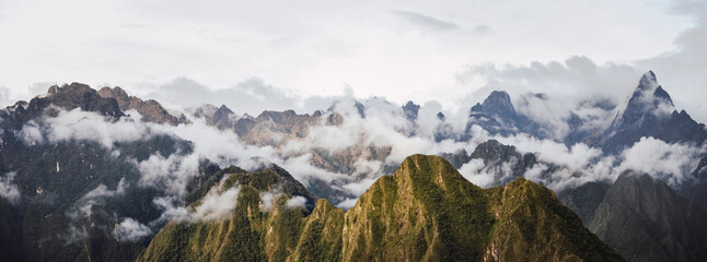 Wall Mural - Panoramic view of cloudy high mountains on the Andes. Inca trail to Machu Picchu archaeological site from the Inca's ancient civilization in Peru. South America