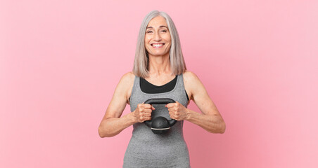 middle age white hair woman lifting a dumbbell. fitness concept