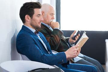 two businessmen waiting for a job interview