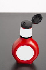 Poster - Tomato sauce bottle with cap on the gray table