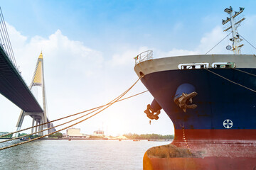 Cargo ships or break-bulk carrier.  Logistics and transportation of container with Bhumibol  bridge in shipyard,Thailand,with sunlight at port,logistic import export and transport industry.