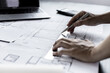 © kamiphotos - Architect engineers are writing house plans in order to modify some of the designs according to the needs of the customers after the proposals are requested to modify the drawings. Interior Design.